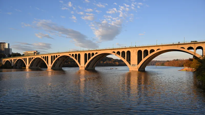 The Georgetown waterfront and Key Bridge on the Potomac at golden hour, Washington, D.C.