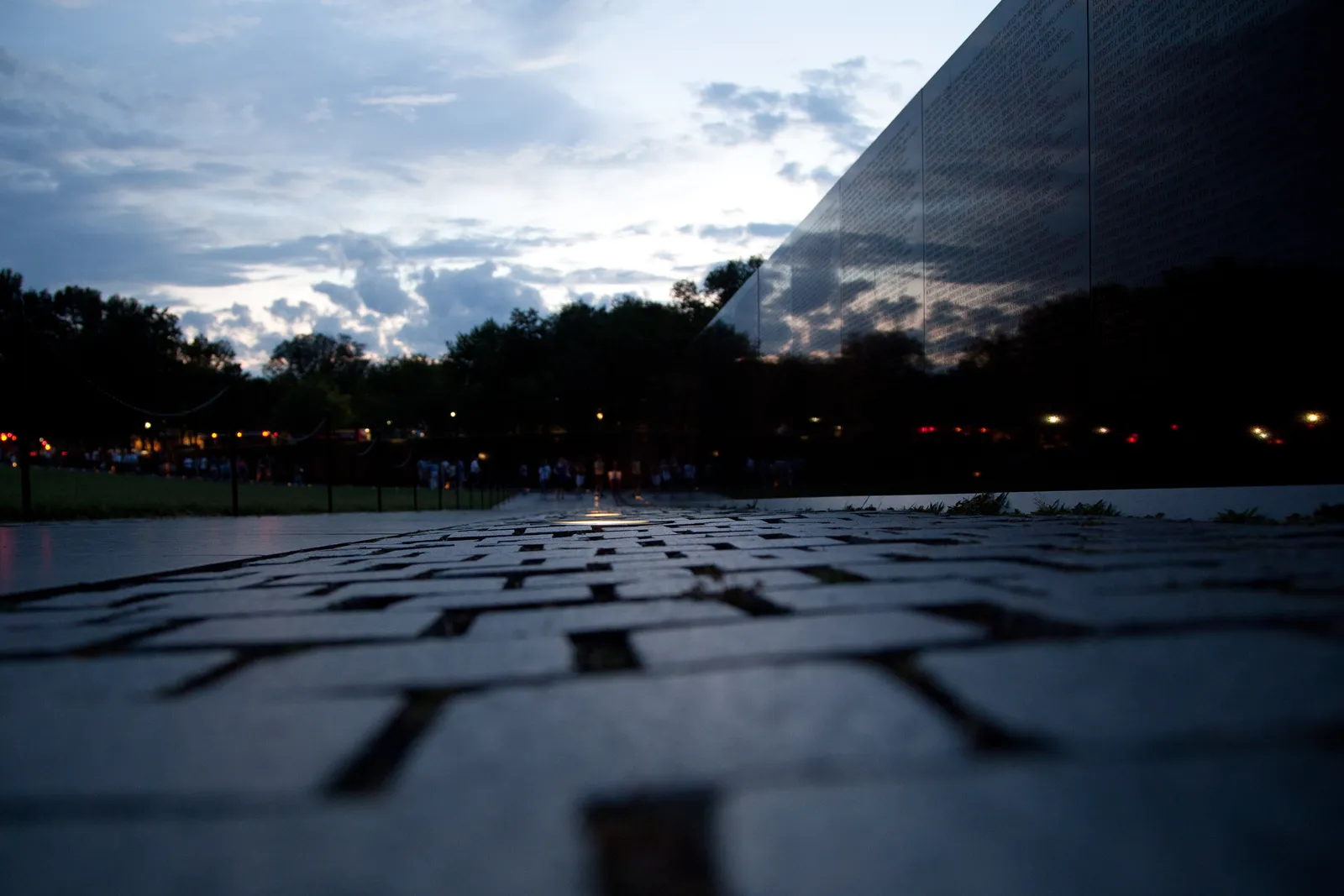 The Vietnam Veterans Memorial Wall, polished black granite carrying engraved names